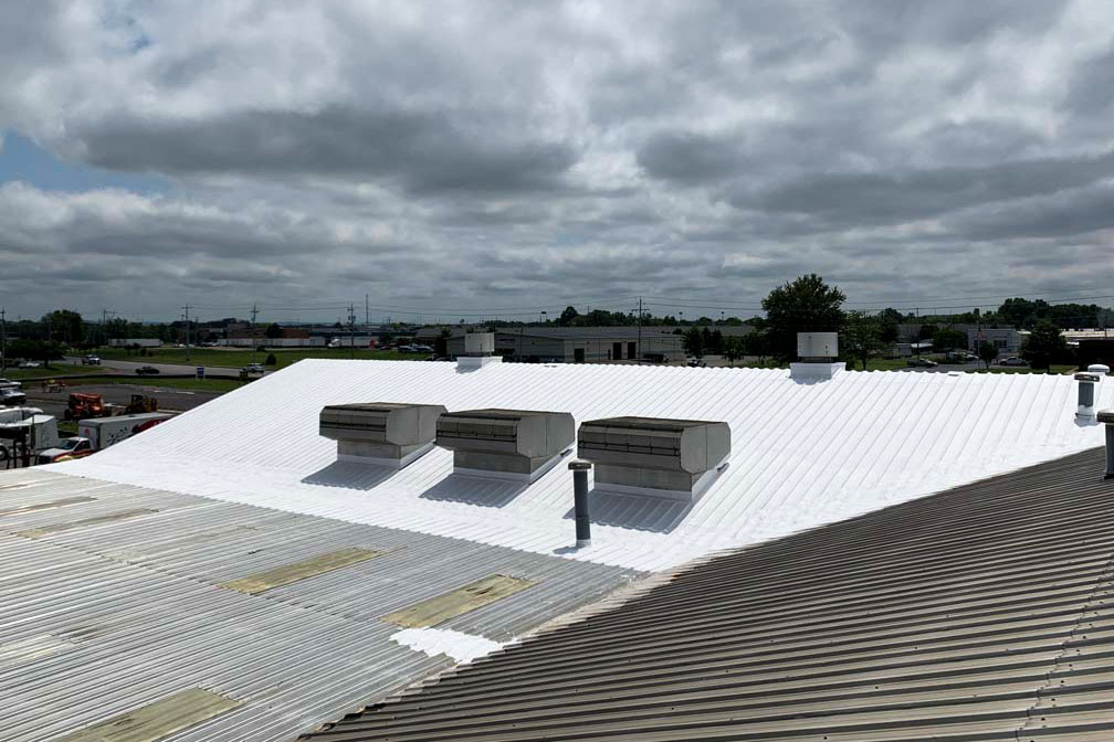 Roof coating being applied by ArmorGuard to the roof of a building to prevent any future leaks.