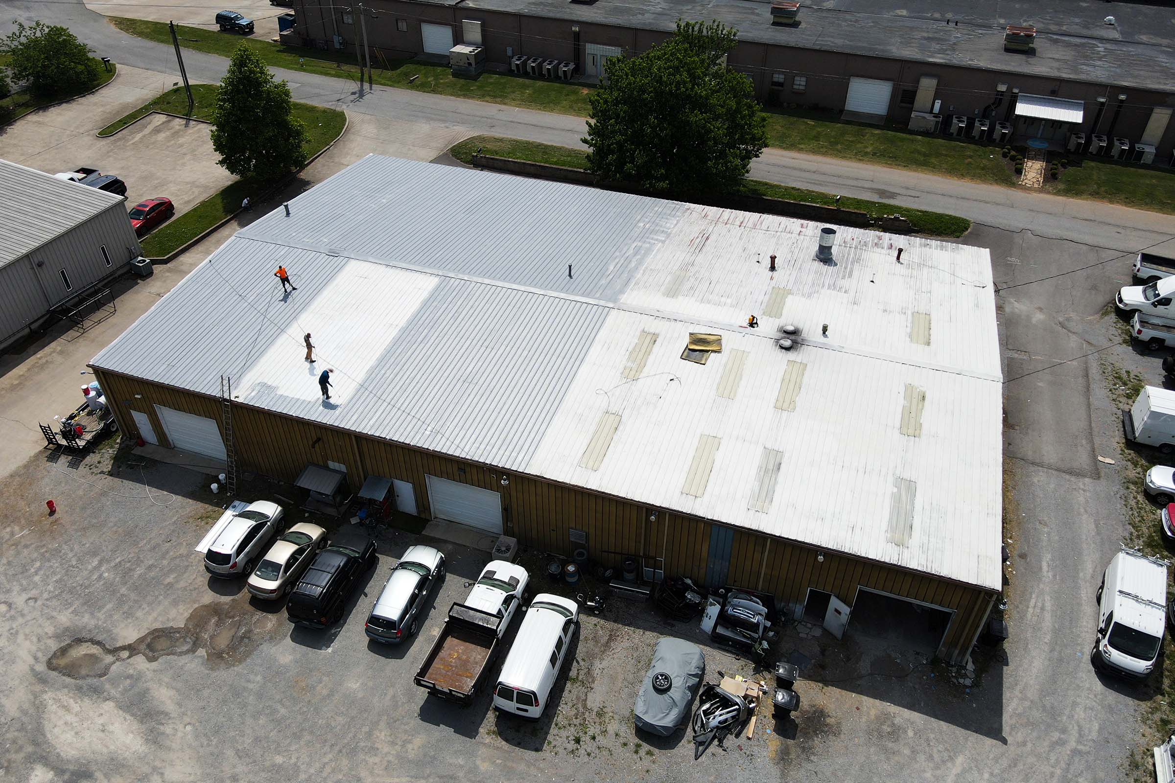 ArmorGuard team applying a roof coating to the roof of a building to prevent any future leaks.